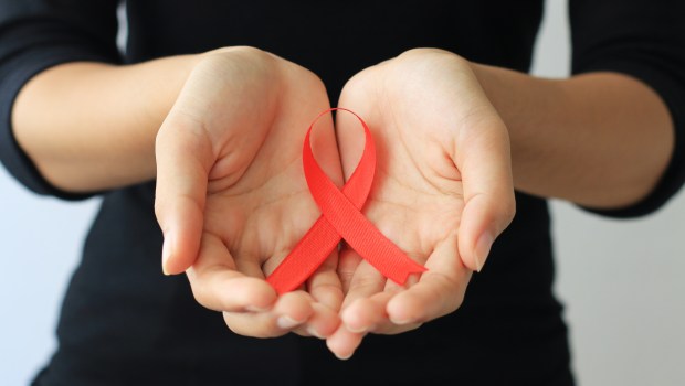 Woman holding red ribbon