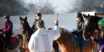 Priest blessing horses