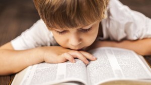 LITTLE BOY READING BIBLE