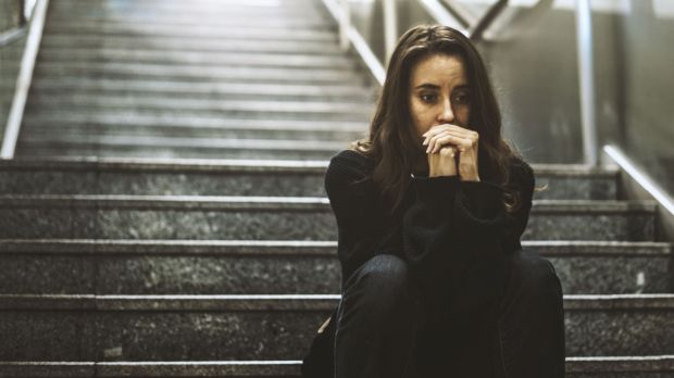 Worried woman on stairway