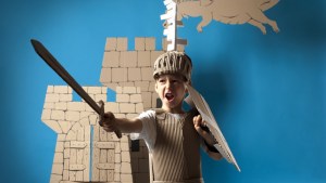boy in medieval knight costume made of cardboards