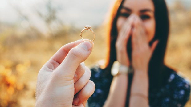 wedding ring with diamond shown to the girl while she is amazed