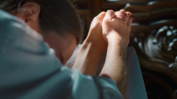 Woman raised her hands to heaven in worship to God in church