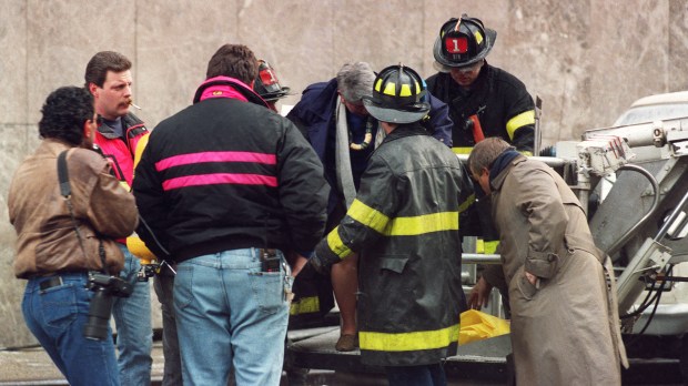Emergency workers attend person injured in World Trade Center attack