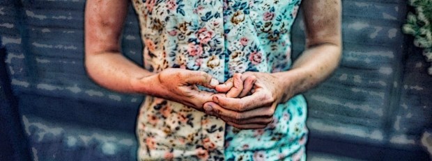 Tense woman picking nails