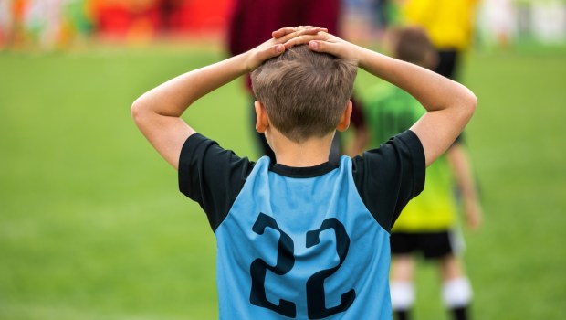 Disappointed Soccer Boy on Football Game