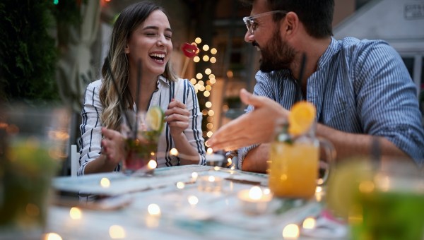 young adult couple talking at cafe