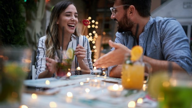 young adult couple talking at cafe